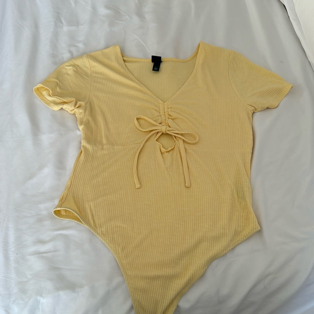 Yellow short sleeve body suit, front cut out